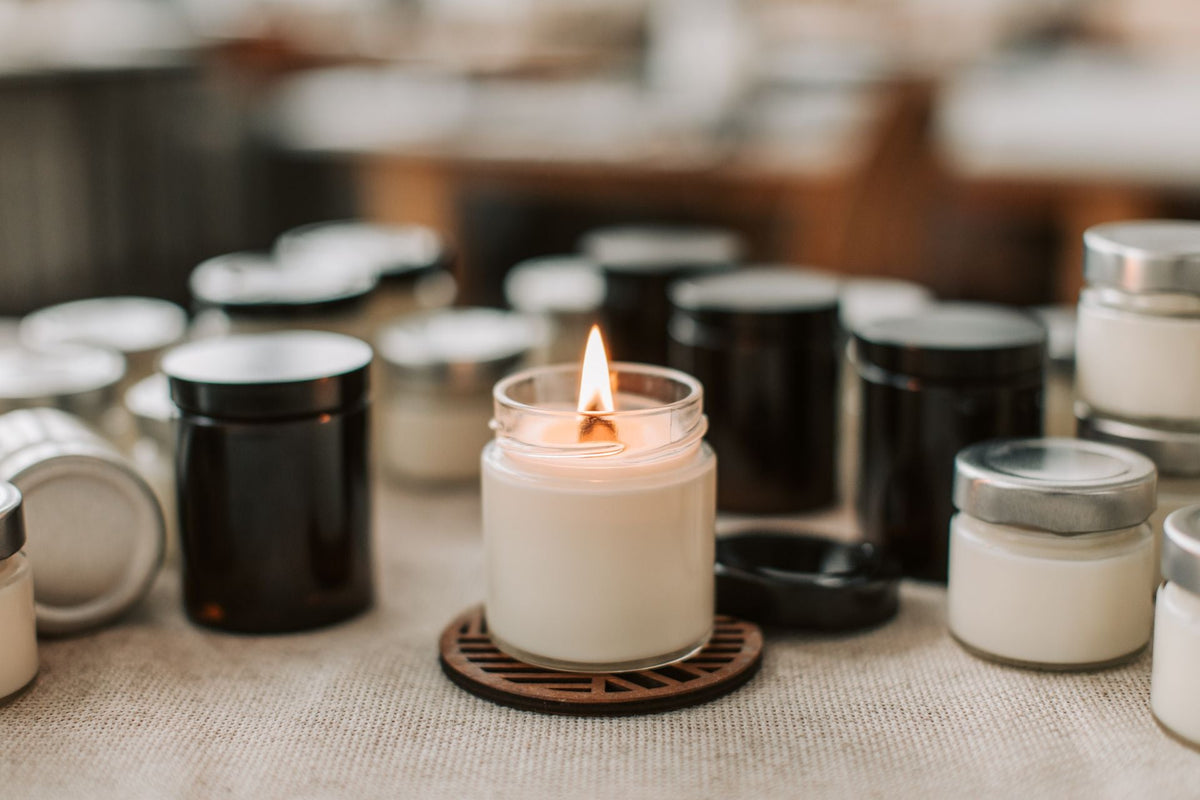 A handmade candle burning among others on the table, the lights the Gullah Geechee traditions keep