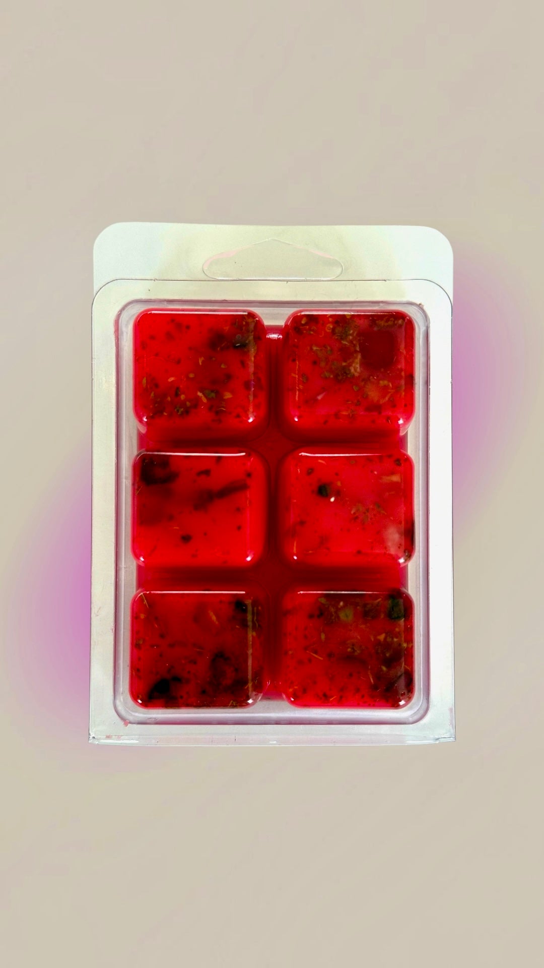 Six red self love Hoodoo wax melt cubes fixed with roots and stones in a clamshell pack