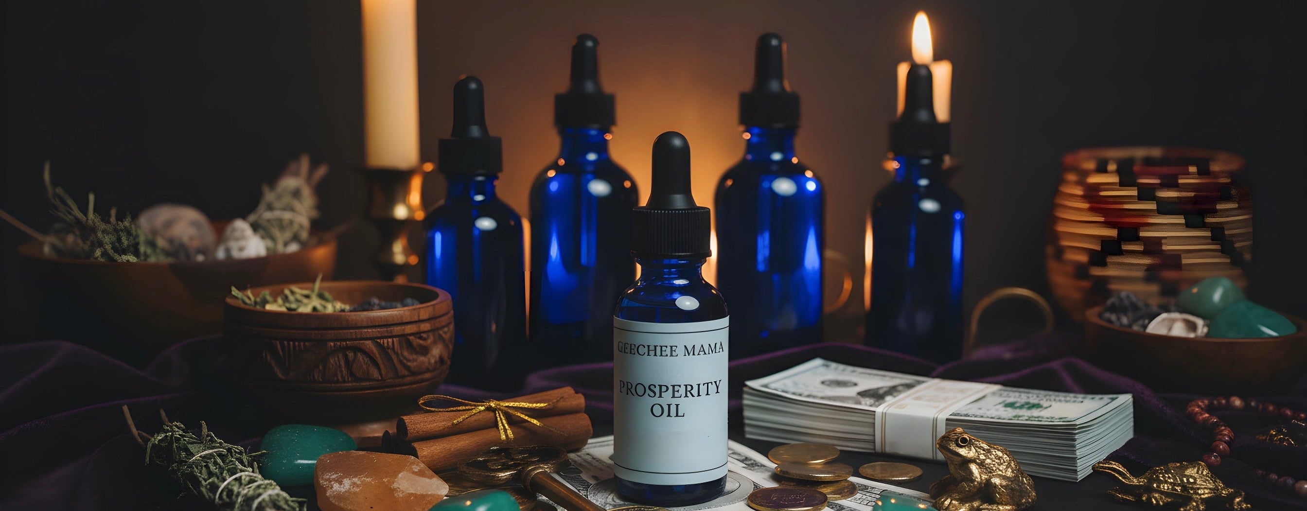 Blue Geechee Mama prosperity oil bottles with labels on a dark surface with candles and coins