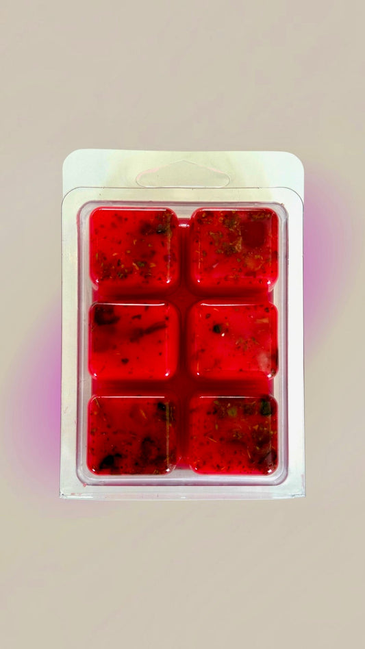 Six red self love Hoodoo wax melt cubes fixed with roots and stones in a clamshell pack