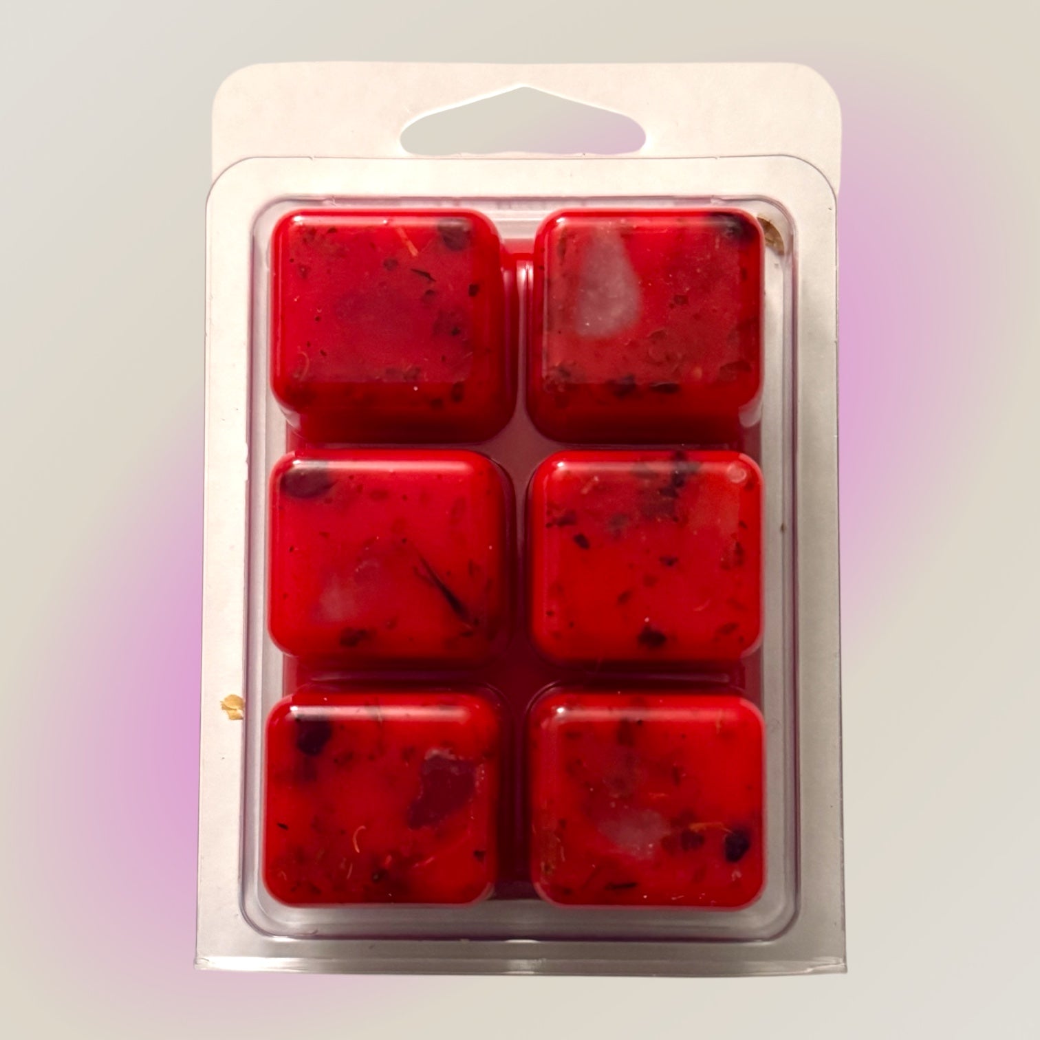 Six red Come To Me Hoodoo wax melt cubes fixed with roots and herbs in a clamshell pack